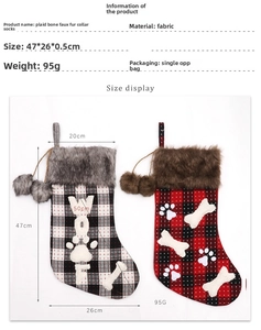 Detailed view of plaid Christmas stocking with fur collar and bone-shaped paw print design