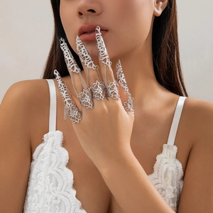 Bracciale ad anello gotico argento con artigli e catene sottili sulla mano della modella
