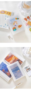 Detail view of frosted translucent mini photo album with decorative stickers and pocket inserts