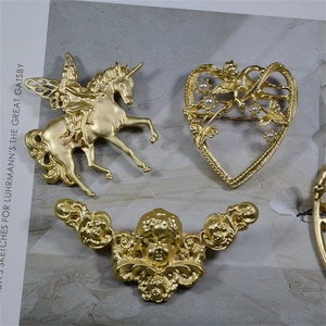 Vintage matte gold brooch set featuring unicorn and angel heart with pearl accents