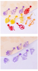 Detailed close-up of colorful geometric acrylic earrings with glitter in various shapes