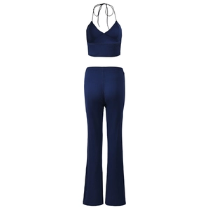 Detail of navy blue two-piece set featuring backless halter top and slim flared trousers