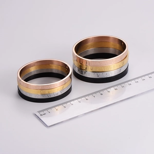 Stacked roman numeral stainless steel bangles in rose gold, gold, silver, and black finishes