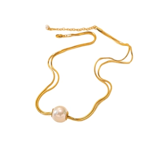 Elegant gold double-layered snake chain necklace featuring a large round pearl pendant