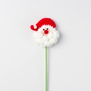 Detail of a handmade crochet Santa Claus ornament with a red hat and white beard