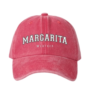 Vintage washed pink cotton baseball cap featuring white Margarita Weather embroidery