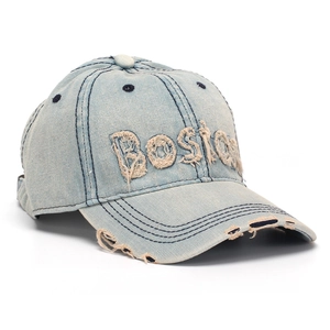 Detail of washed denim baseball cap with Boston embroidery and distressed ripped accents