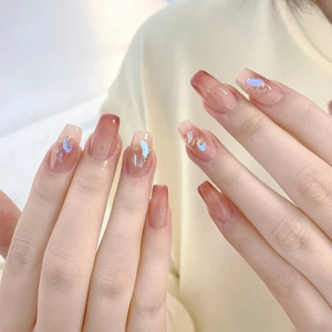 Brown gradient press-on nails with blue and gold shimmer in long coffin shape