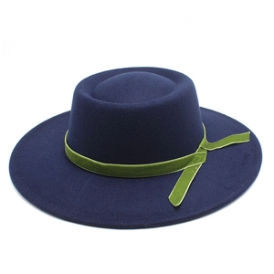 Detail of wool felt fedora with navy blue finish and green velvet ribbon trim