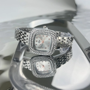 Close-up of silver square watch with rhinestones and 925 certification on metal strap