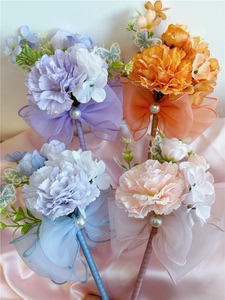 Detailed close-up of handmade carnation pens in purple, orange, blue and pink