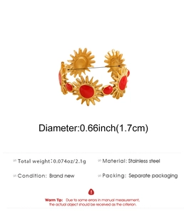 Detailed macro view of 18K gold stainless steel sunburst ring with red enamel inlay
