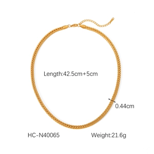Detail showing gold wheat chain necklace texture with lobster clasp and extension chain