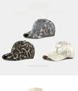 Detailed view of three jacquard leopard print baseball caps in grey, gold, and cream colors