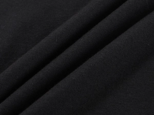 Close-up of soft black knitted fabric texture and fine stitching on a slim fit t-shirt