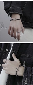 Close-up of double-layered titanium steel chain bracelet and multi-layer ring for men