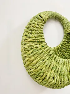 Detailed close-up showing the tight weave and texture of the natural corn husk wall basket