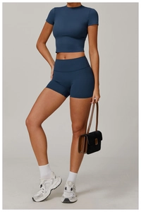 Detail of high-waist yoga shorts and cropped short sleeve top in navy blue sporty fabric