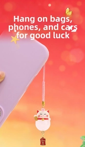 Detail of Fortune Cat charm with Ruyi plaque and pink woven lanyard for bags
