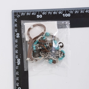 Detail view of bohemian turquoise bead necklace with silver pendants and scale measure