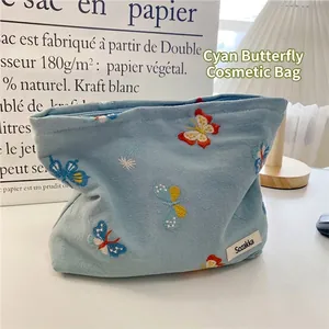 Light blue canvas makeup bag featuring exquisite butterfly embroidery and zip closure