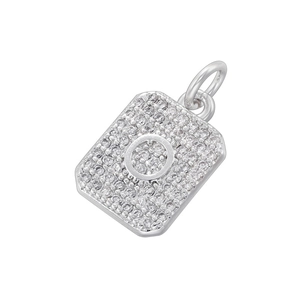 Macro shot of silver rectangular pendant with zircon pavé setting and letter O detail
