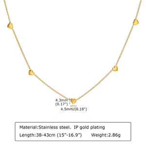 Detail of 18K gold-plated stainless steel necklace with small heart pendants and specs