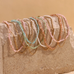 Macro detail of 18K gold-plated double-layer anklet with vibrant colorful stone beads