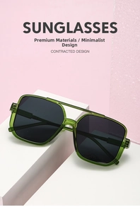 Detail view of square green transparent sunglasses frame with dark lenses on display