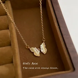 Elegant 18K gold butterfly necklace with zircon stones in a velvet jewelry box