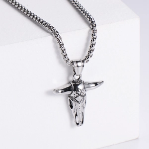 Macro view of a hollowed bull skull pendant necklace in silver stainless steel