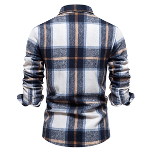 Detail of plaid men's long-sleeve shirt back view showing navy and orange flannel texture