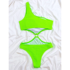 Detail of neon green one-shoulder swimsuit featuring waist cutout and metal ring connector