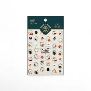 Halloween nail stickers featuring ghosts and gold-edged black cats on a green card