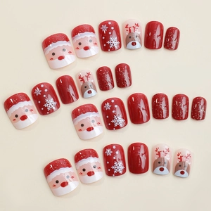 Short round Christmas press-on nails with Santa, reindeer, and snowflake designs