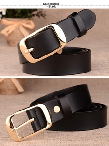 Detail of black leather belt featuring a textured surface and elegant gold metal pin buckle