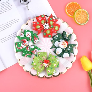 Detailed view of 4-piece Christmas ribbon hair bows with festive holiday patterns