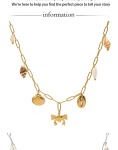 Detail of gold and silver crab and shell pendants on a paperclip chain ocean necklace