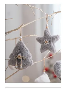 Close-up of plush grey faux fur Christmas star and tree ornaments with wooden accents