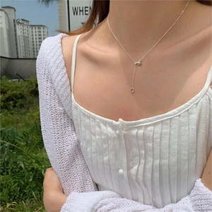 Silver Y-shaped long necklace with sleek teardrop pendant and metallic bead accents