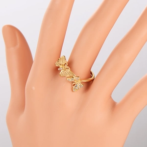 Fashionable gold butterfly ring with sparkling rhinestones shown on a model hand