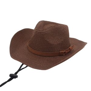 Detail of dark brown raffia cowboy hat featuring woven texture and adjustable wind rope