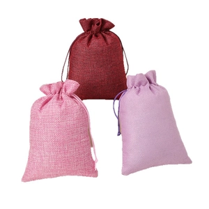 Linen drawstring jewelry pouches in red pink and purple colors on white background
