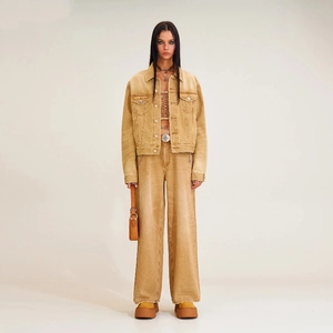 Detail of khaki denim jacket outfit featuring notched lapel and high-waist trousers
