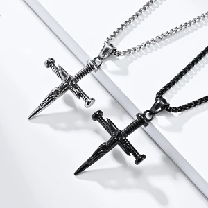Detail of vintage sword cross necklaces in silver and black finish with metal relief