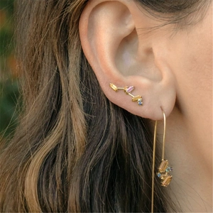 Close-up of S925 silver gold-plated C-shaped hoop earrings with colorful crystals on model