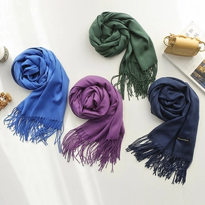 Classic solid color cashmere feel scarves with fringe in multiple colors on white backdrop