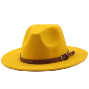 Bright yellow wide-brim fedora hat with brown studded leather band on white background