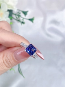 Macro detail of square cut blue gemstone ring with pave diamonds and 925 silver finish