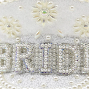 Detail of BRIDE bridal captain hat with white sequins, pearls and rhinestone accents